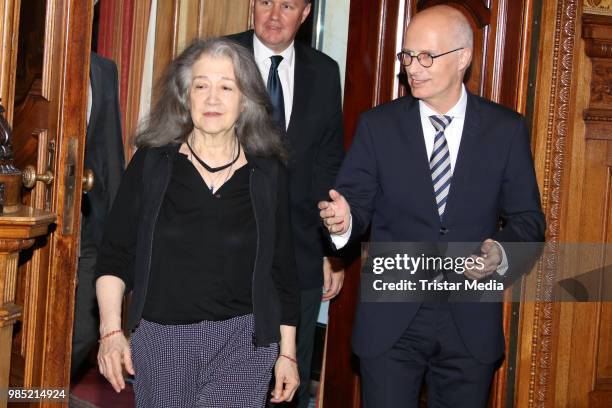 Swiss-Argentinian pianist Martha Argerich and Peter Tschentscher, mayor of Hamburg during she signs the golden book at Hamburg City Hall on June 27,...