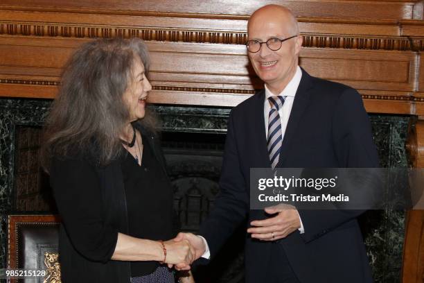 Swiss-Argentinian pianist Martha Argerich and Peter Tschentscher, mayor of Hamburg during she signs the golden book at Hamburg City Hall on June 27,...