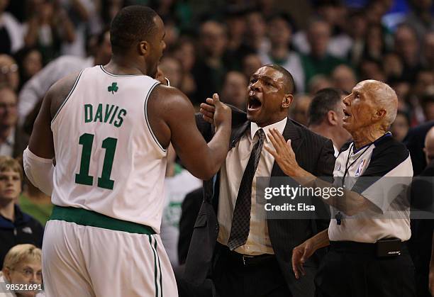 Head coach Doc Rivers of the Boston Celtics sends Glen Davis to the bench during an altercation in front of the Miami Heat bench during Game One of...