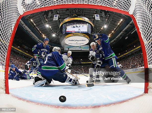 The shot of Anze Kopitar of the Los Angeles Kings gets by Roberto Luongo of the Vancouver Canucks for the overtime winning goal as Sami Salo and...