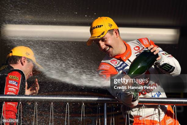 Jamie Whincup of Team Vodafone sprays champagne over the balcony after winning race eight of the Hamilton 400, which is round four of the V8 Supercar...