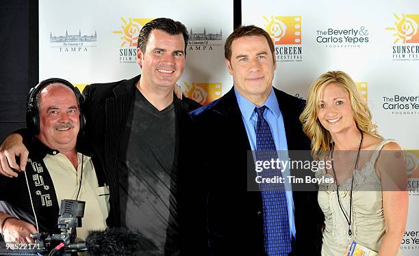 John Travolta poses with fans at the Sunscreen Film Festival awards ceremony at the Mirror Lake Lyceum on April 17, 2010 in St Petersburg, Florida.