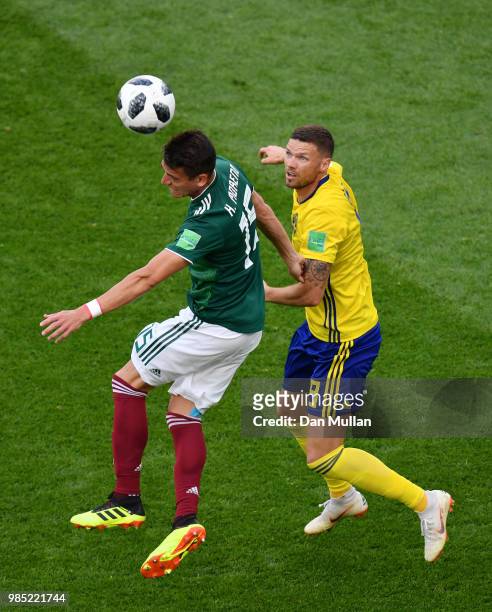 Hector Moreno of Mexico wins a header over Marcus Berg of Sweden during the 2018 FIFA World Cup Russia group F match between Mexico and Sweden at...