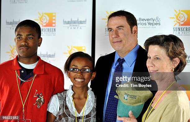 John Travolta poses with fans at the Sunscreen Film Festival awards ceremony at the Mirror Lake Lyceum on April 17, 2010 in St Petersburg, Florida.