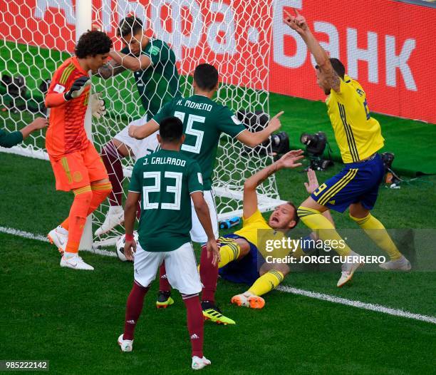 Sweden's defender Andreas Granqvist goes down after a melee in the box after a free kick during the Russia 2018 World Cup Group F football match...