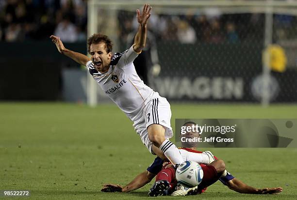 Mike Magee of the Los Angeles Galaxy is tackled by Alvaro Saborio of Real Salt Lake in the second half at the Home Depot Center on April 17, 2010 in...