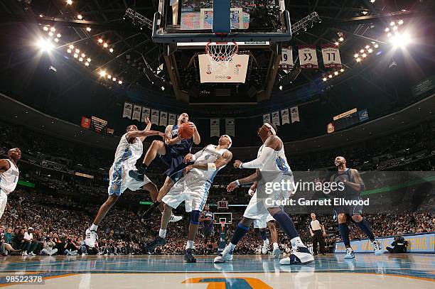 Deron Williams of the Utah Jazz goes to the basket against Aaron Afflalo and Kenyon Martin of the Denver Nuggets in Game One of the Western...