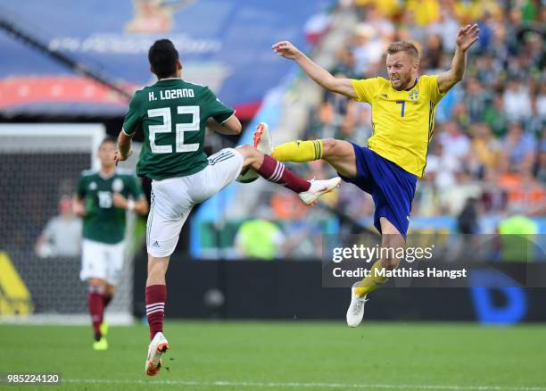 Sebastian Larsson of Sweden clashes with Hirving Lozano of Mexico during the 2018 FIFA World Cup Russia group F match between Mexico and Sweden at...