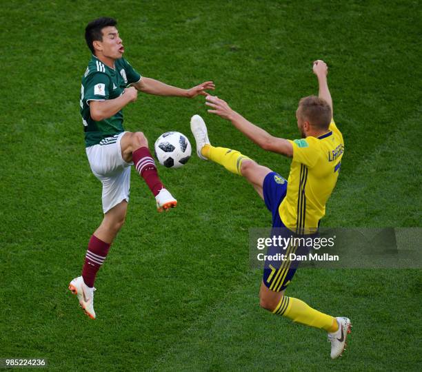 Sebastian Larsson of Sweden clashes with Hirving Lozano of Mexico during the 2018 FIFA World Cup Russia group F match between Mexico and Sweden at...