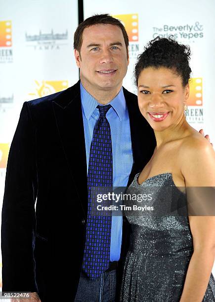 John Travolta poses with actress Ayanna Berkshire at the Sunscreen Film Festival awards ceremony at the Mirror Lake Lyceum on April 17, 2010 in St...
