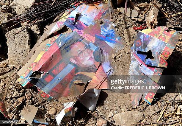 Torn portrait of the Dalai Lama is seen among the rubble of quake damaged buildings in Jiegu, Yushu County, on April 16, 2010 resulting from the...