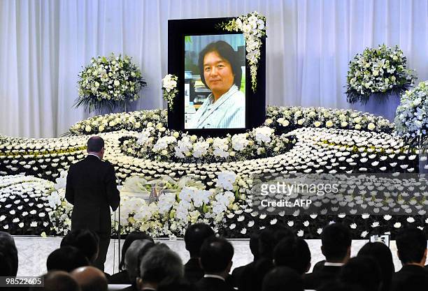 Thomson Reuters editor-in-chief David Schlesinger delivers his speech in front of an altar set up for the late Thomson Reuters cameraman Hiro...