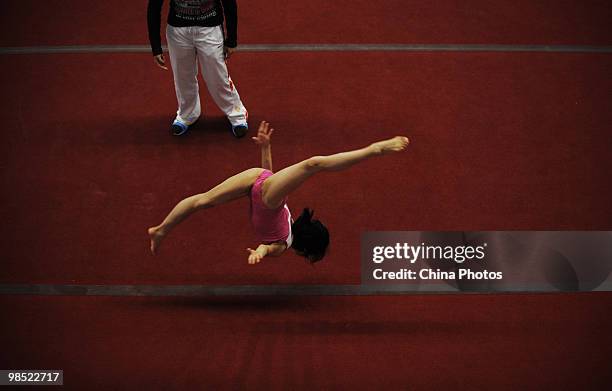 An athlete attends a training session under the instructions of a coach during the 2010 Training Camp For Country's Reserve Gymnastic Athletes at the...