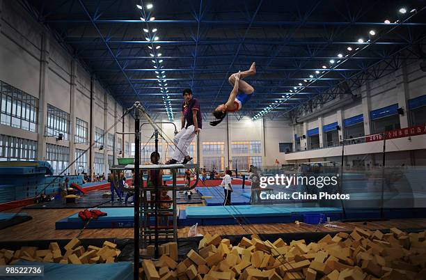 An athlete attends a training session under the instructions of a coach during the 2010 Training Camp For Country's Reserve Gymnastic Athletes at the...