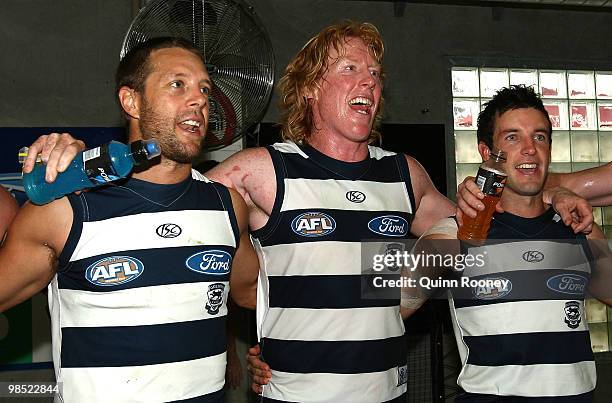 David Wojcinski, Cameron Ling and Shannon Byrnes of the Cats sing the song in the rooms after winning the round four AFL match between the Geelong...