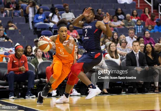 Connecticut Sun guard Jasmine Thomas charges past Washington Mystics forward Myisha Hines-Allen during a WNBA game between the Washington Mystics and...