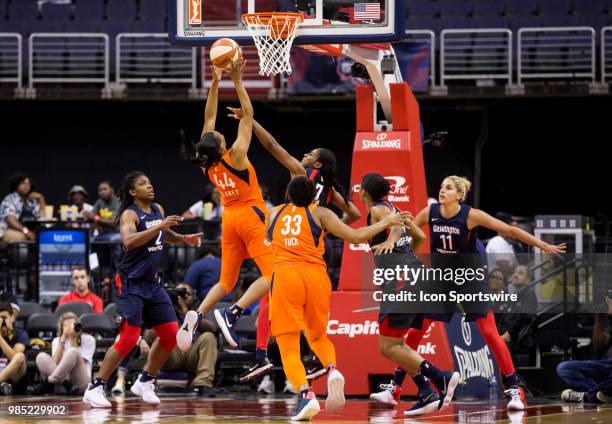 Connecticut Sun forward Betnijah Laney lobs a shot over Washington Mystics guard Ariel Atkins during a WNBA game between the Washington Mystics and...
