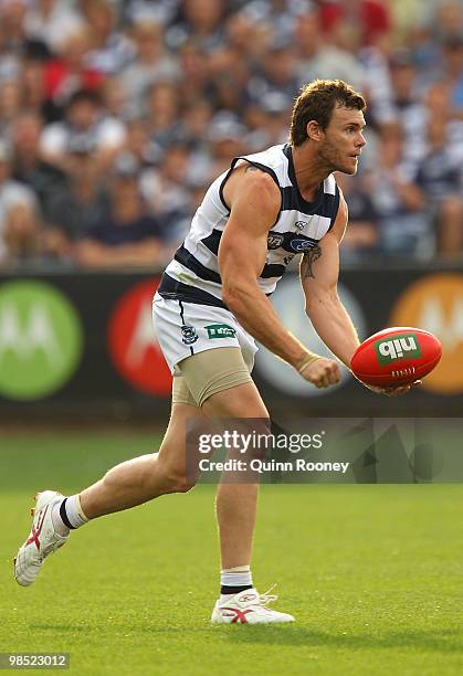 Cameron Mooney of the Cats handballs during the round four AFL match between the Geelong Cats and the Port Adelaide Power at Skilled Stadium on April...