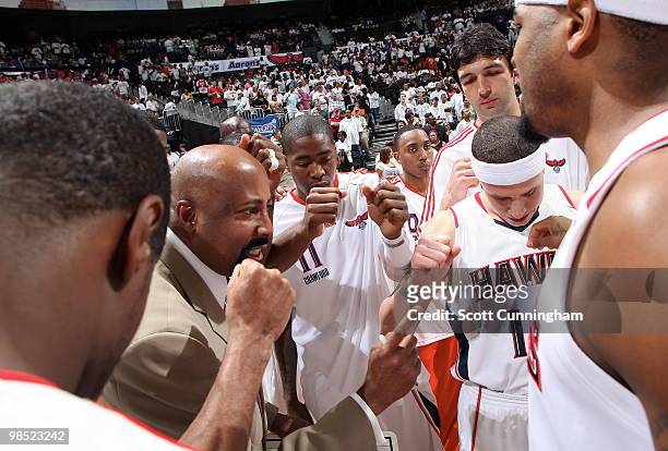 Head Coach Mike Woodson of the Atlanta Hawks encourages his team before tipoff against the Milwaukee Bucks in Game One of the Eastern Conference...