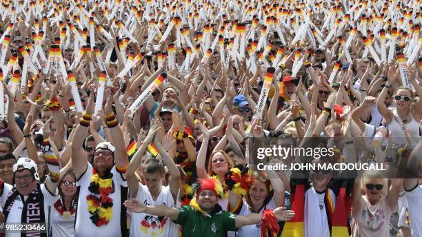 Supporters of the German national football team cheer as they attend a public viewing event at the Fanmeile in Berlin to watch the Russia 2018 World...