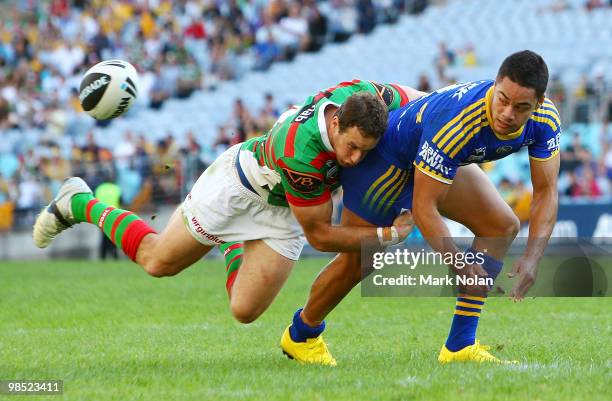 Jarryd Hayne of the Eels offloads as Colin Best of the Rabbitohs tackles during the round six NRL match between the Parramatta Eels and the South...