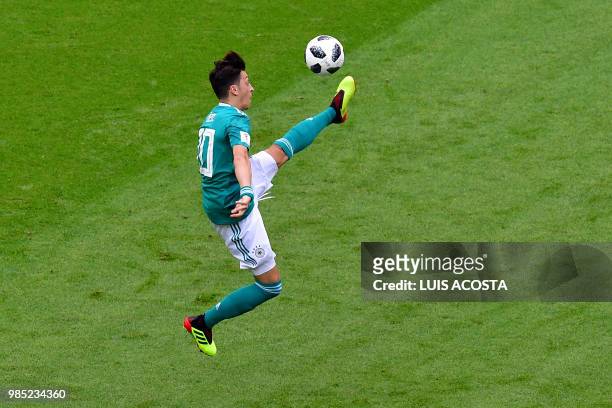 Germany's midfielder Mesut Ozil jumps to control the ball during the Russia 2018 World Cup Group F football match between South Korea and Germany at...