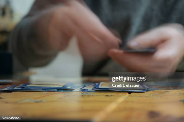 two hands shuffle board game cards with motion blur. - karten mischen stock-fotos und bilder