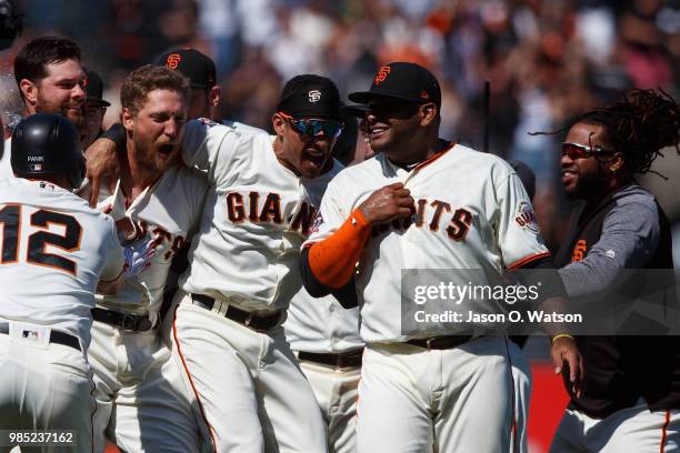 Hunter Pence of the San Francisco Giants is congratulated by teammates after hitting a two run walk off double against the San Diego Padres after the...