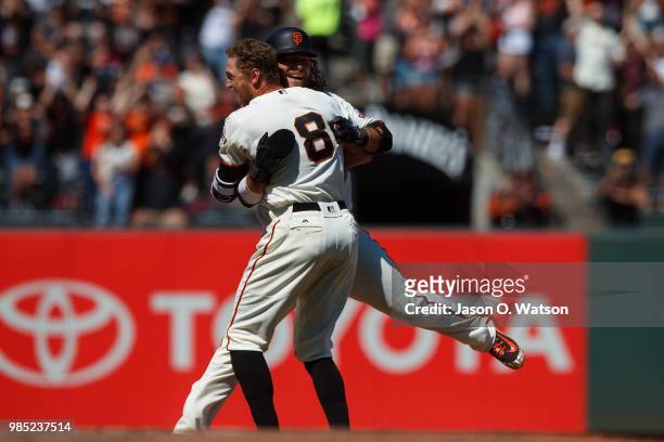 Hunter Pence of the San Francisco Giants is congratulated by Brandon Crawford after hitting a two run walk off double against the San Diego Padres...