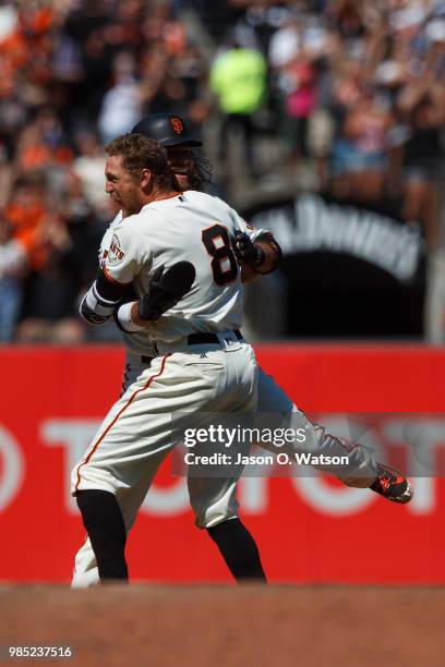 Hunter Pence of the San Francisco Giants is congratulated by Brandon Crawford after hitting a two run walk off double against the San Diego Padres...