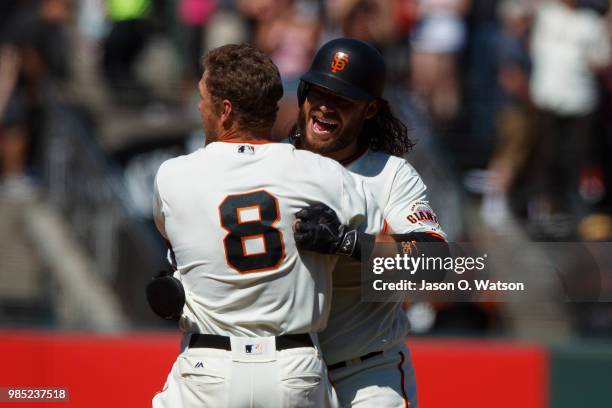 Hunter Pence of the San Francisco Giants is congratulated by Brandon Crawford after hitting a two run walk off double against the San Diego Padres...