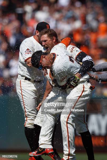 Hunter Pence of the San Francisco Giants is congratulated by teammates after hitting a two run walk off double against the San Diego Padres after the...