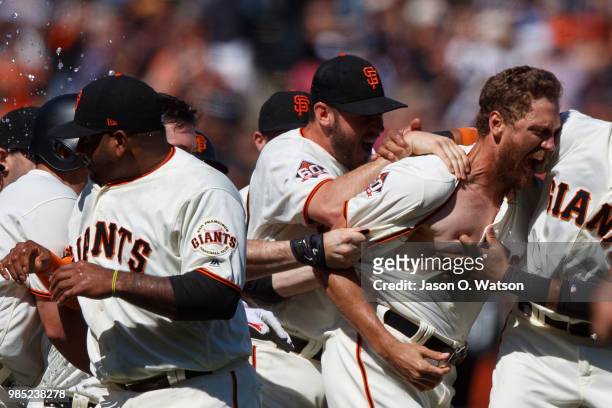 Hunter Pence of the San Francisco Giants is congratulated by teammates after hitting a two run walk off double against the San Diego Padres after the...