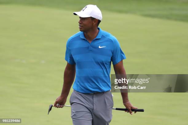 Tiger Woods walks to the fifth green with his putter on while playing in the Pro-Am prior to the Quicken Loans National at TPC Potomac on June 27,...