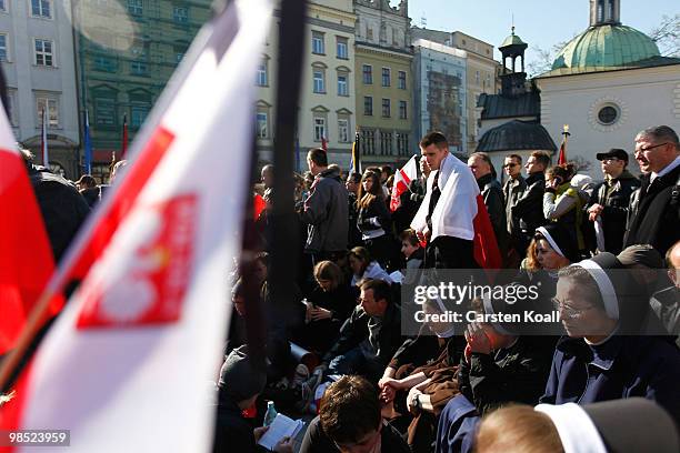 People follow as the coffins of late Polish President Lech Kazcynski and his wife Maria arrive at the St Mary's Basilica on April 18, 2010 in Krakow,...