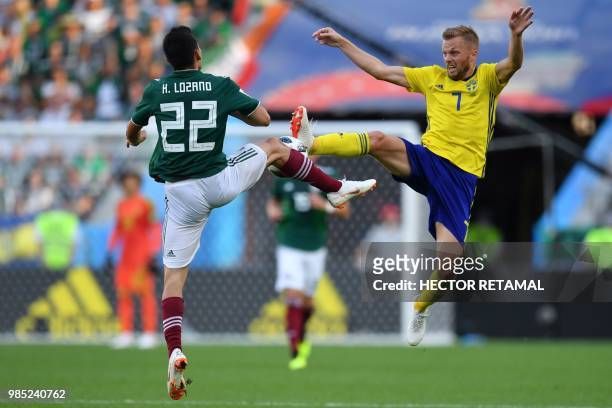 Mexico's forward Hirving Lozano and Sweden's midfielder Sebastian Larsson vie for the ball during the Russia 2018 World Cup Group F football match...