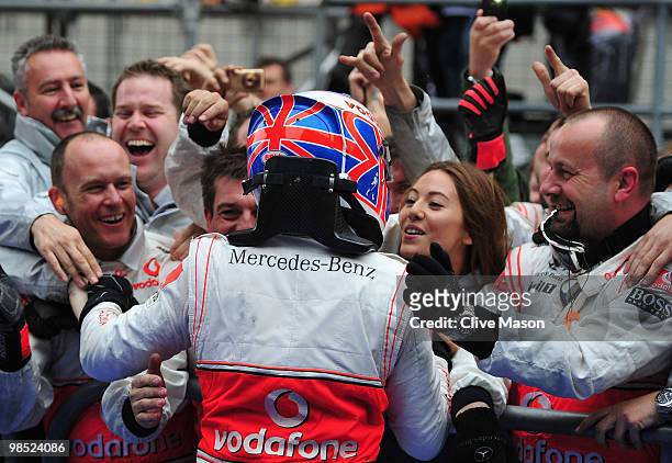 Jenson Button of Great Britain and McLaren Mercedes celebrates in parc ferme with team mates and girlfriend Jessica Michibata after winning the...