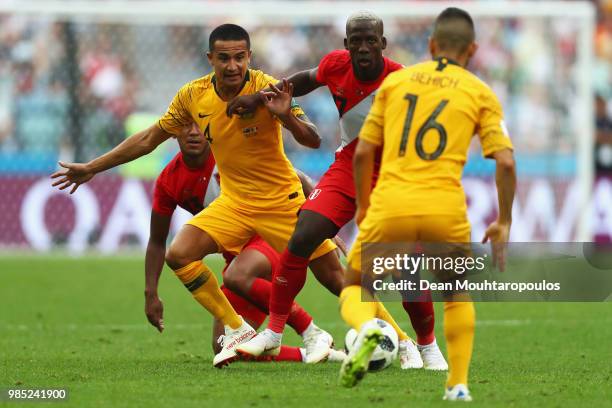 Tim Cahill of Australia battles for the ball with Aldo Corzo and Luis Advincula of Peru during the 2018 FIFA World Cup Russia group C match between...