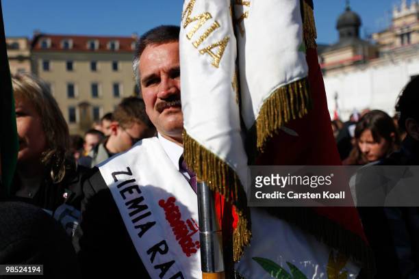 Man follows as the coffins of late Polish President Lech Kazcynski and his wife Maria arrive at the St Mary's Basilica on April 18, 2010 in Krakow,...