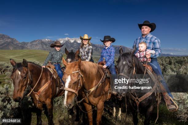 happy family on horseback - family formal portrait stock pictures, royalty-free photos & images