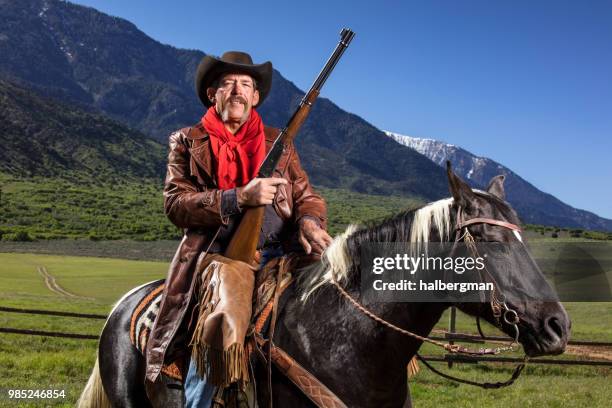 Cowboy With Reed Cowboy With Rifle Photos and Premium High Res Pictures - Getty Images