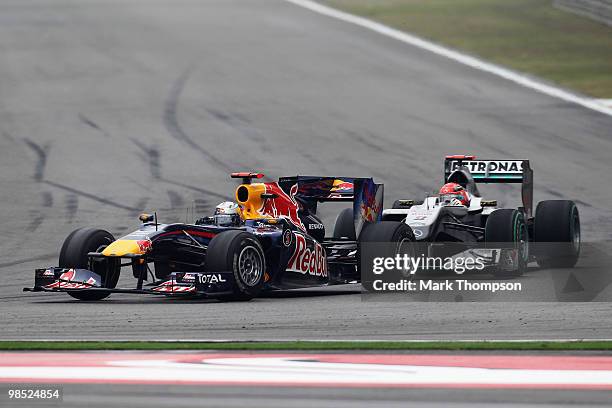 Sebastian Vettel of Germany and Red Bull Racing leads from Michael Schumacher of Germany and Mercedes GP during the Chinese Formula One Grand Prix at...