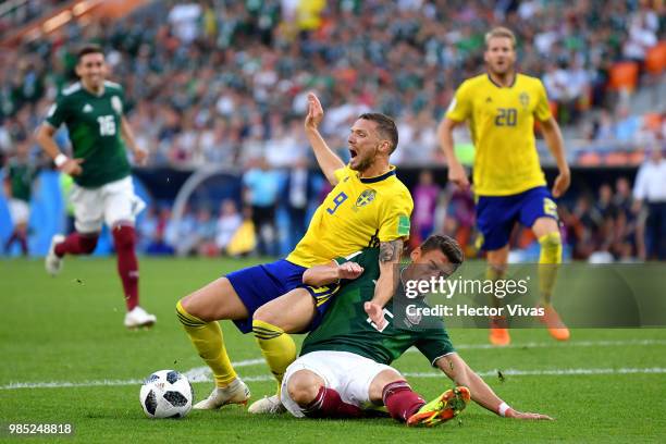 Hector Moreno of Mexico fouls Marcus Berg of Sweden inside the box to concede a penalty during the 2018 FIFA World Cup Russia group F match between...