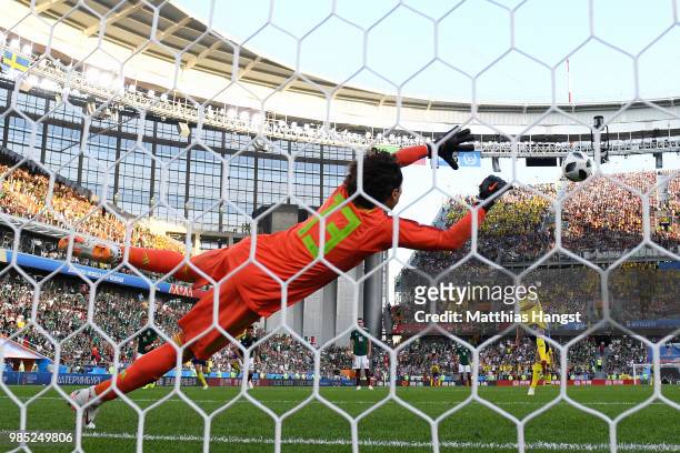 Andreas Granqvist of Sweden scores past Guillermo Ochoa of Mexico his team's second goal from the penalty spot during the 2018 FIFA World Cup Russia...