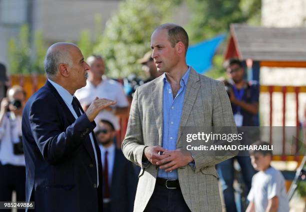 Head of the Palestinian Football Federation, Jibril Rajoub , talks to Britain's Prince William in the West Bank city of Ramallah on June 27, 2018....