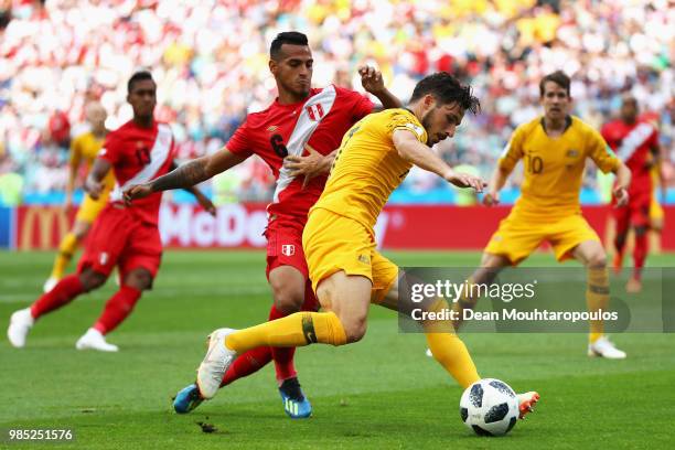 Yoshimar Yotun of Peru battles for the ball with Matthew Leckie and Joshua Risdon of Australia during the 2018 FIFA World Cup Russia group C match...