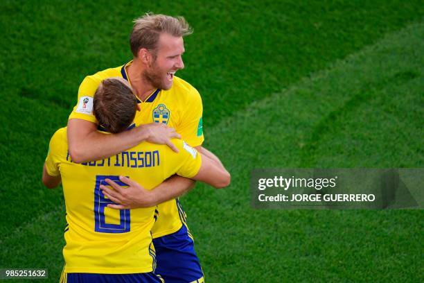 Sweden's defender Ludwig Augustinsson celebrates scoring the opening goal with his teammate forward Ola Toivonen during the Russia 2018 World Cup...