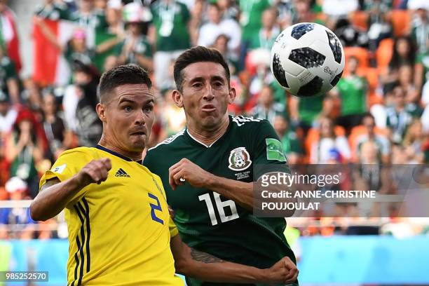 Sweden's defender Mikael Lustig and Mexico's midfielder Hector Herrera vie for the ball during the Russia 2018 World Cup Group F football match...