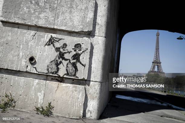 Recent artwork by street artist Banksy is pictured in Paris on June 27 near the Eiffel Tower . - Street artist Banksy has confirmed that he "blitzed"...