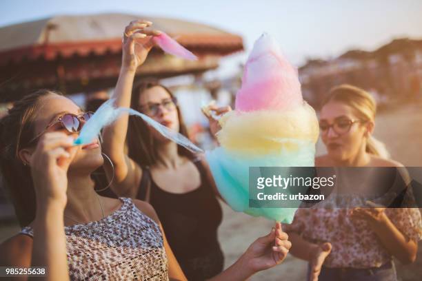 girls eating cotton candy at the county fair - cotton candy stock pictures, royalty-free photos & images